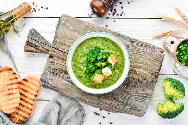 Brokoli, kızarmış ekmek ile bir kapta ıspanak krema çorbası. Yeşil çorba. Diyet yemekleri. Üstte görüntü.