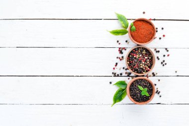 Karabiber, renkli biber, deniz tuzu, karabiber, kurutulmuş biber. Üst te. Beyaz bir arka plan üzerinde. metniniz için boş alan.