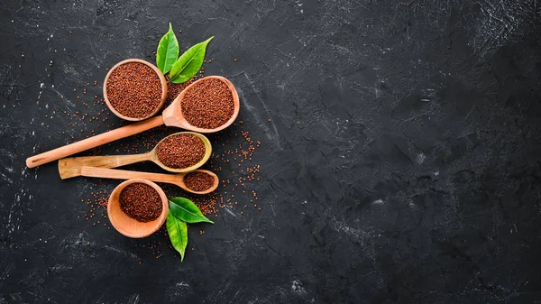 Superfood Red quinoa. On a black background. Top view. Free copy space.