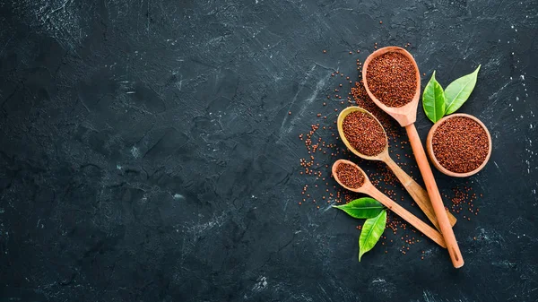 Superfood Red quinoa. On a black background. Top view. Free copy space.