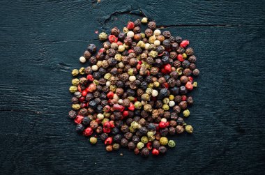 Tahta bir arka plan üzerinde kırmızı ve karabiber. Baharatlar Üst görünüm. Metniniz için boş alan.