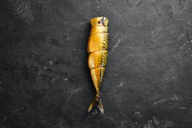 Füme Balık Uskumru. Siyah taş bir arka plan üzerinde. Üst te. Ücretsiz kopyalama alanı.