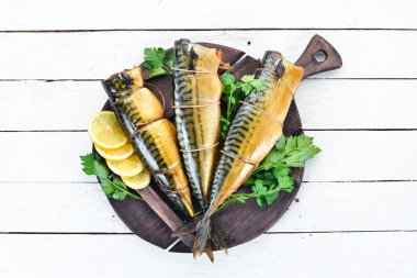 Smoked fish Mackerel. On a white wooden background. Top view. clipart