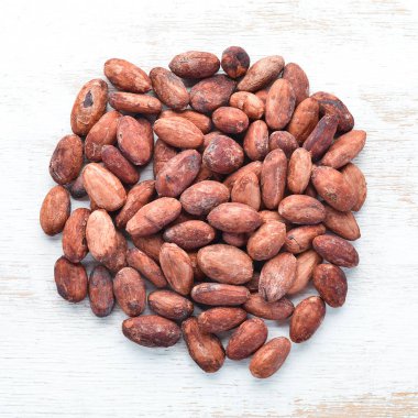 Beyaz arka planda kakao çekirdekleri. Üst te. Ücretsiz kopyalama alanı.