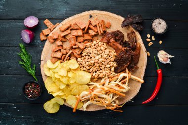 Biraya atıştırmalık. Cips, tuzlu fındık, kurutulmuş balık eti. Eski arka planda. ücretsiz kopyalama alanı.