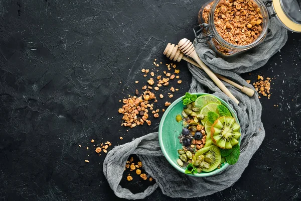 Yeşil spirulina, kivi, nane ve kabak çekirdeği ile Smoothie kase. Kahvaltı. Üst te. Metniniz için boş alan.