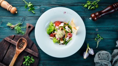 Brie peynir, kiraz domates ve ıspanak ile sebze salatası. Tabakta. Üst te. Metniniz için boş alan. Rustik stil.