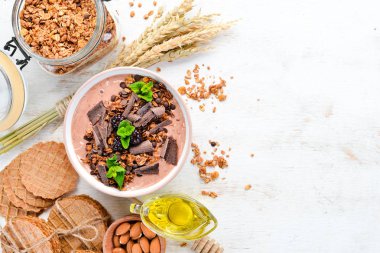 Bir kase yoğurt, granola, çikolata ve çilek ile taze kahvaltı. Üst te. Metniniz için boş alan.