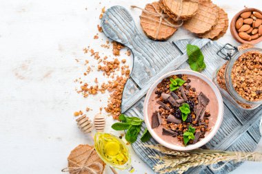Bir kase yoğurt, granola, çikolata ve çilek ile taze kahvaltı. Üst te. Metniniz için boş alan.