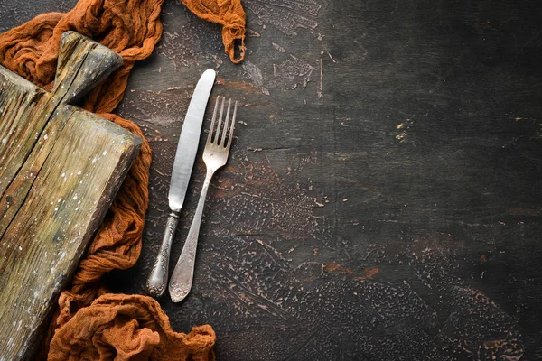 Old cutlery on a dark background. Top view. Free copy space.