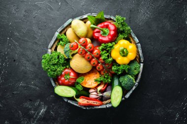 Tahta bir kutuda taze sebze ve meyveler. Avokado, domates, çilek, kavun, patates, kırmızı biber, narenciye. Üst te. Metniniz için boş alan.