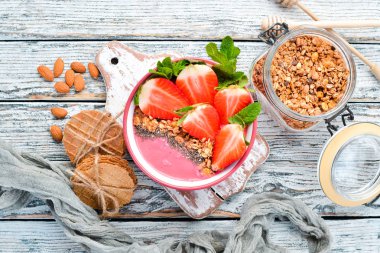 Taze çilek, granola, yoğurt ve chia tohumu ile Smoothie kase. Kahvaltı. Üst te. Metniniz için boş alan.