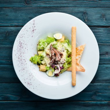 Dana eti ile Sebze Sezar Salatası. Tabakta. Üst te. Metniniz için boş alan. Rustik stil.