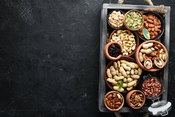 Set nuts and dried fruit in a wooden box. Top view. Free space for your text.
