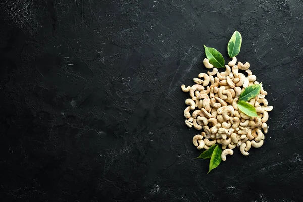 Cashew on a black background. Nuts Top view. Free space for your text.