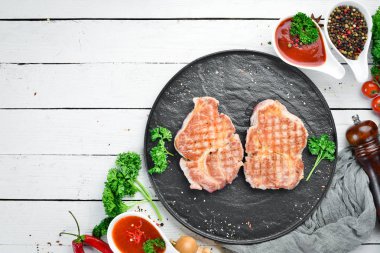 Baharat ve otlar ile ızgara domuz biftek. Üst te. Metniniz için boş alan.