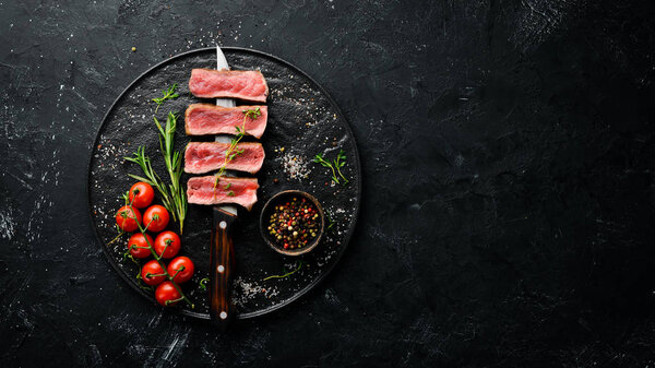 Juicy Steak on the knife. Top view. Free space for your text.