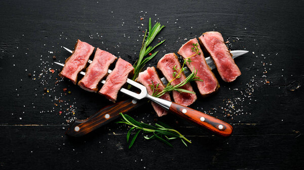 Juicy Steak on the knife. Top view. Free space for your text.