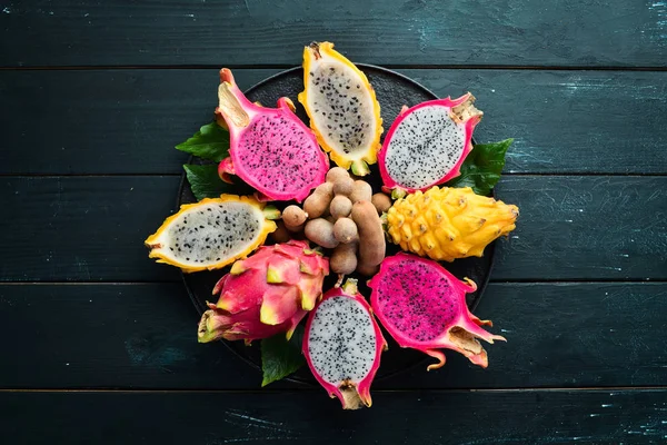 Fresh Dragon Fruit on a Black Background. Tropical Fruits. Top view. Free space for text.