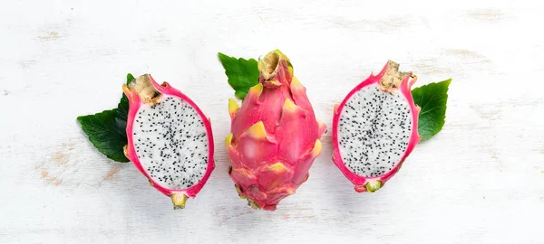 Fruit dragon on a white wooden background. Pitahaya Tropical Fruits. Top view. Free space for text.