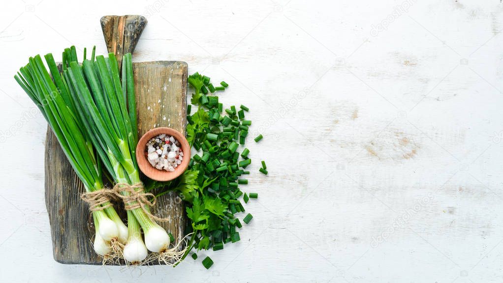 Slice green onions on a Wooden Table. Fresh vegetables. Top view. Free space for text.