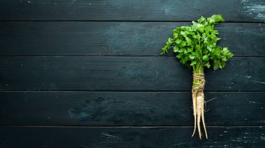 Ahşap bir arka planda kök maydanoz. Üst görünüm. Metniniz için boş alan.