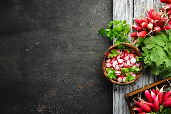 Sliced radishes on a Wooden Table. Fresh vegetables. Top view. Free space for text.