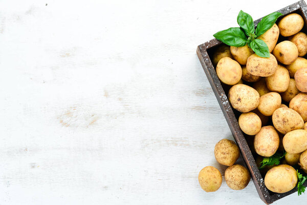 Fresh potatoes in the box. Organic food. Top view. Free space for text.