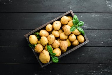 Fresh potatoes in the box. Organic food. Top view. Free space for text. clipart