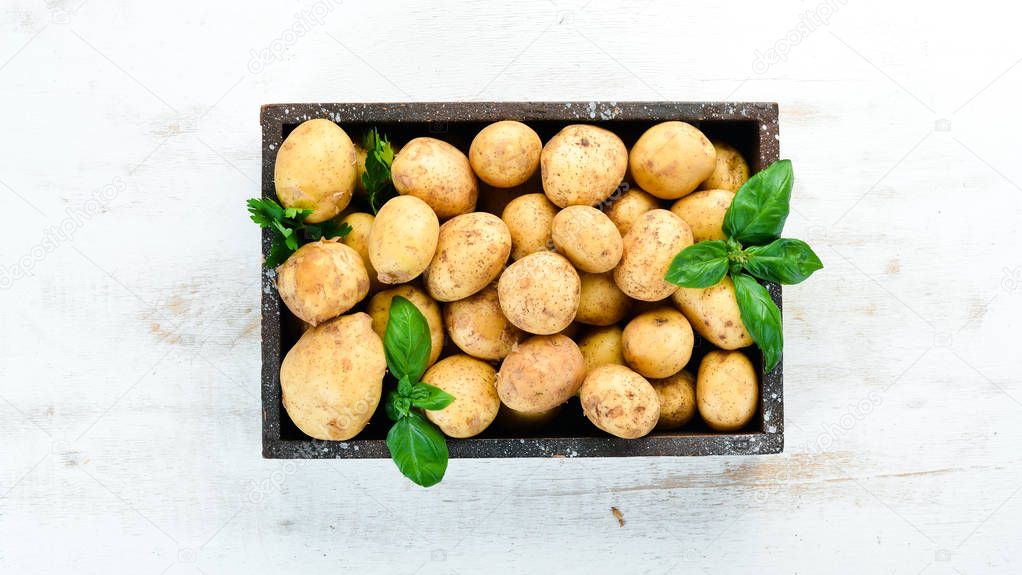 Fresh potatoes in the box. Organic food. Top view. Free space for text.