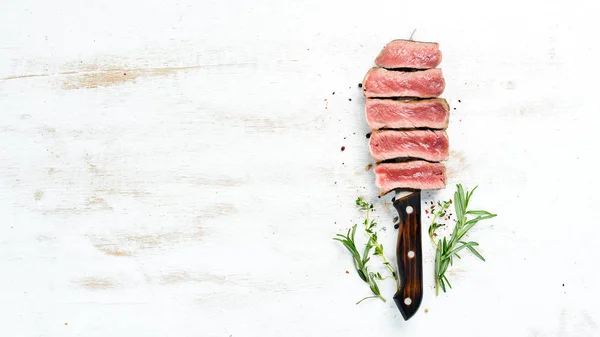 Juicy Steak on the knife. Top view. Free space for your text.