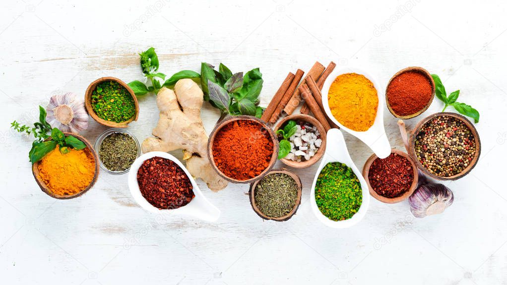 Various spices in a bowls on white background. Indian spices. Top view.