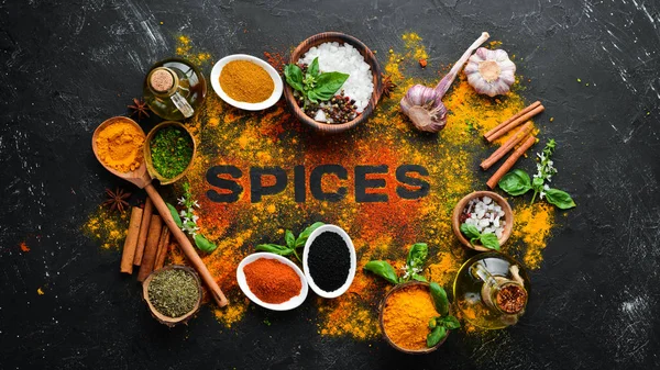 Indian spices on a black stone background. The word \