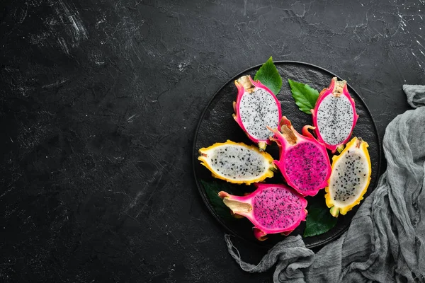 Fresh Dragon Fruit on a Black Background. Tropical Fruits. Top view. Free space for text.