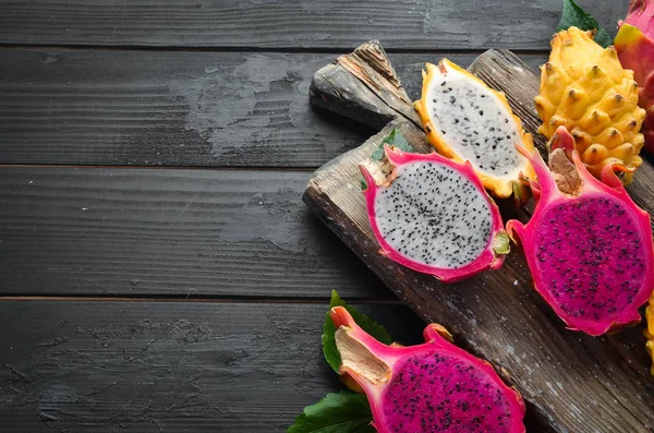 Fresh Dragon Fruit on a Black Background. Tropical Fruits. Top view. Free space for text.