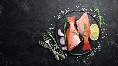 Limon ve biberiye ile balık çiğ Snapper. Siyah bir arka planda. Üst görünüm. Metniniz için boş alan.