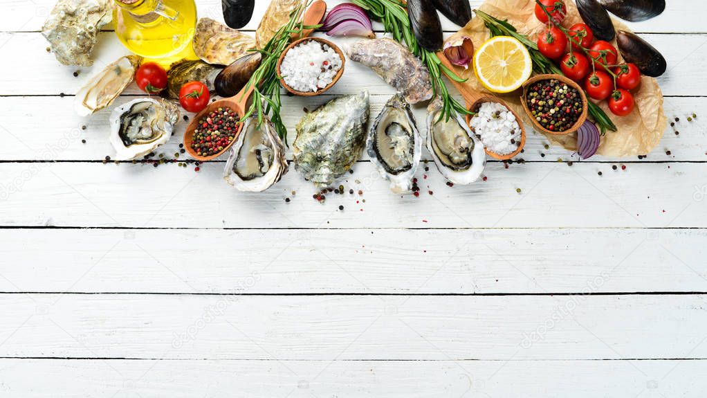 Fresh Oyster with Lemon. Seafood. Top view. On a white wooden background. Free copy space.