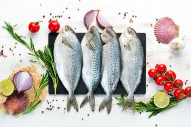 Limon, tuz ve biberiye ile çiğ balık. Beyaz ahşap bir arka plan üzerinde. Üst te. Ücretsiz kopyalama alanı.