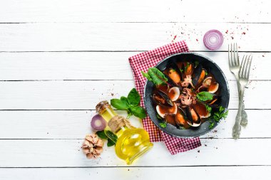 Deniz mahsullü domates çorbası. Midye, istiridye ve ahtapot. Eski arka planda. Üst te. Ücretsiz kopyalama alanı.
