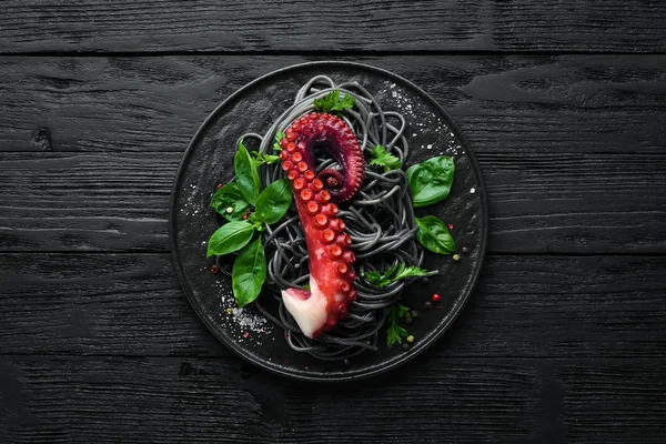 Black Pasta Octopus Tentacles Seafood Stone Plate Old Background Top — Stock Photo, Image