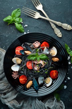 Deniz ürünleri ile makarna. Siyah macun. Deniz ürünleri. Üst te. Ücretsiz kopyalama alanı.