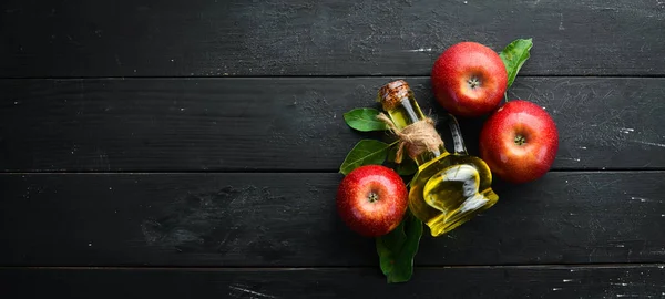 Apples and apple vinegar on the old background. Fruits. Top view. Free space for text.