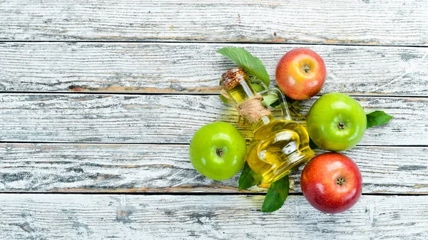 Apples and apple vinegar on the old background. Fruits. Top view. Free space for text.