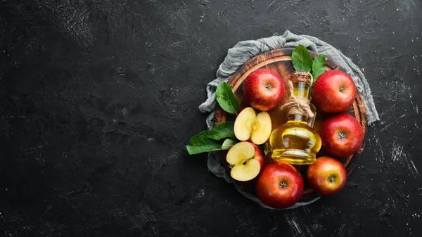 Apples and apple vinegar on the old background. Fruits. Top view. Free space for text.