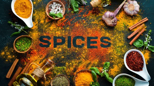 Indian spices on a black stone background. The word \