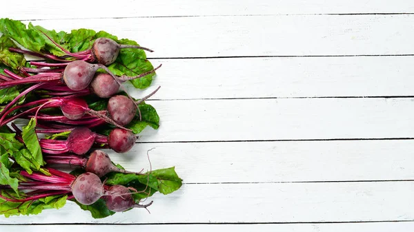 Fresh beet on a white wooden background. Healthy food. Top view. Free space for your text.