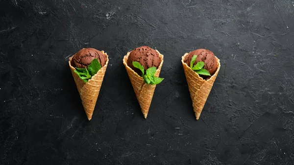 Chocolate ice cream in a waffle cup. Top view. Free space for your text.