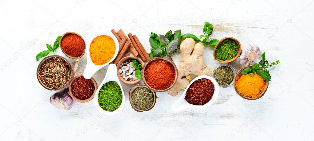 Various spices in a bowls on white background. Indian spices. Top view.