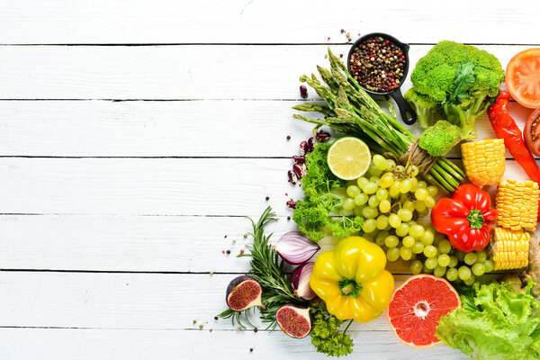 Fresh vegetables and fruits on a white background. Top view. Free copy space.