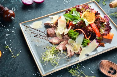 Dana eti ve parmesan peynirli sebze salatası. Üst te. Metniniz için boş alan.